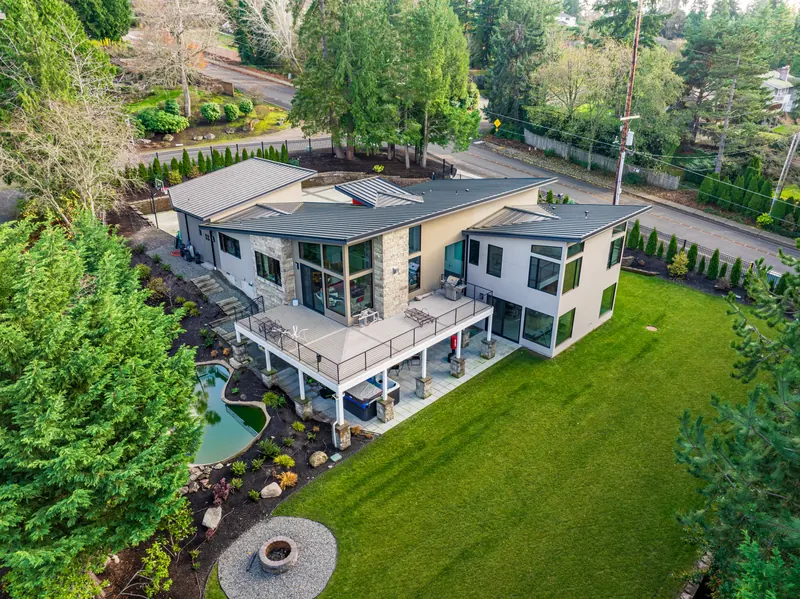 Aerial view of the custom home, deck, lawn and landscaping
