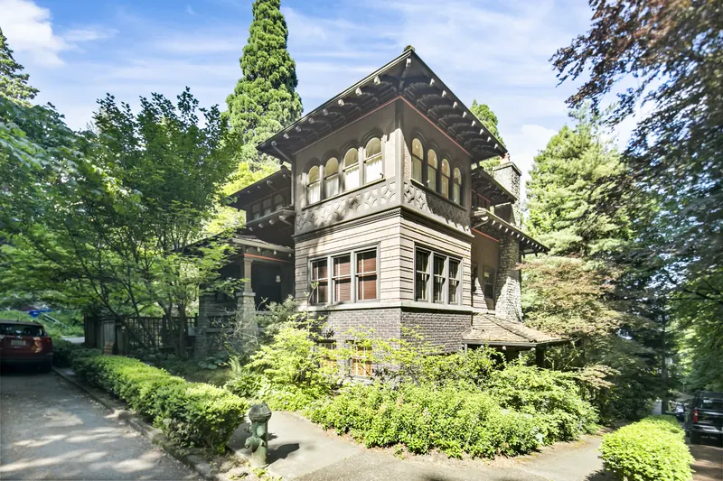 Historic Craftsman home surrounded by mature trees