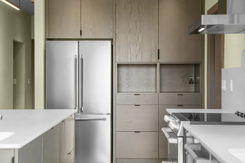Custom oak built-in cabinetry around the refrigerator in a Seattle kitchen